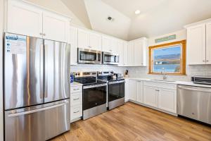 a kitchen with white cabinets and a stainless steel refrigerator at 6120 - Yankee Clipper in Nags Head