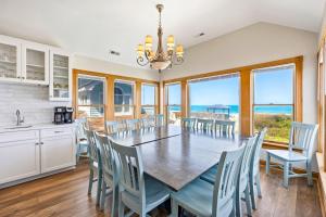 a kitchen and dining room with a table and chairs at 6120 - Yankee Clipper in Nags Head