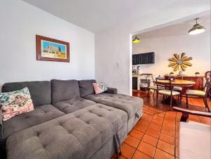 a living room with a couch and a dining room at Casa Blanca Condominio in La Paz
