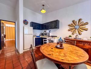 a kitchen with a wooden table and a refrigerator at Casa Blanca Condominio in La Paz +5 photos