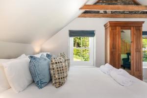 a bedroom with a white bed with pillows and a window at 4 Bed in St. Brides oc-h30490 in Saint Brides