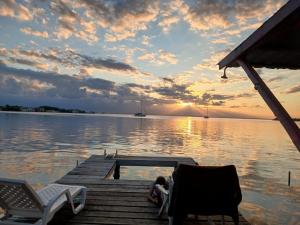 a person laying on a dock on a lake at Villa Bahia Del Sol in Bocas Town