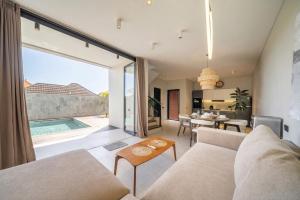 an open living room with a view of a pool at Grey Stones - Private Pool Villa with Rooftop in Ungasan