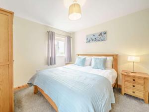 a bedroom with a large white bed and a window at 3 Bed in Poulton-le-fylde oc-41764 in Preesall