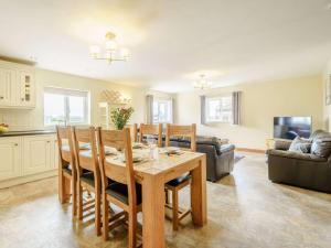a kitchen and living room with a wooden table and chairs at 3 Bed in Poulton-le-fylde oc-41764 in Preesall +19 photos