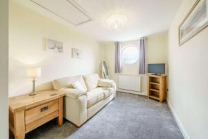 a living room with a couch and a television at 3 Bed in Poulton-le-fylde oc-41764 in Preesall