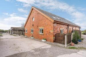 a brick building with a fence in front of it at 3 Bed in Poulton-le-fylde oc-41764 in Preesall