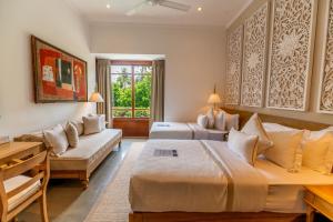 a hotel room with two beds and a couch at The Villa by Contemporary Ceylon in Wadduwa +60 photos