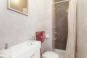 a bathroom with a sink and a toilet and a shower at Goabio Apartment 3 Riverview in Porto