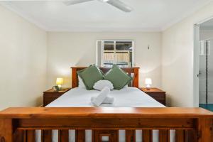a bedroom with a bed with a teddy bear on it at Comfortable 4BR Coomer Escape Close to Everything in Gold Coast