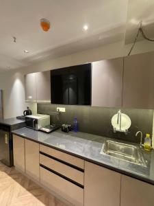 a kitchen with a sink and a microwave at LaCasa Heights in Greater Noida