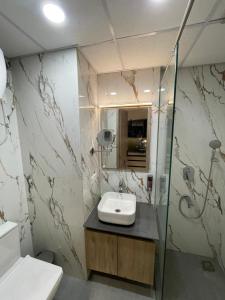 a bathroom with a sink and a shower at LaCasa Heights in Greater Noida