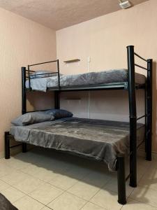a bedroom with two bunk beds in a room at Hostal Punto Americana in Guadalajara