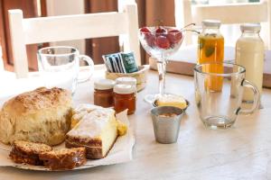 a table with a plate of bread and other foods at Quita penas in Los Reartes