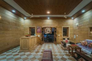 a living room with wooden walls and a couch and a table at Gj02 desert resort in Jaisalmer