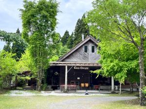 a building with a sign that says cool genes at Guesthouse Coco Garage in Kirishima