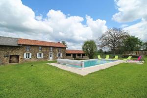 a yard with a swimming pool in front of a building at La reille in Cussac