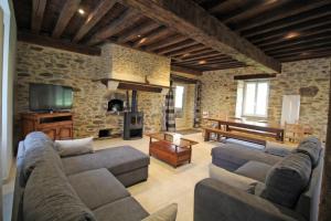 a living room with a couch and a table and a piano at La reille in Cussac