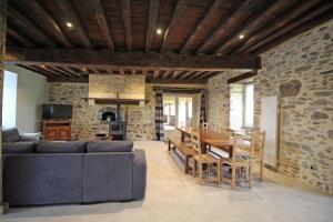 a living room with a blue couch and a table at La reille in Cussac