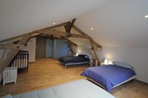 a bedroom with two beds in a attic at La reille in Cussac +34 photos