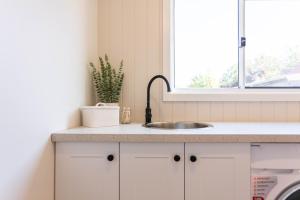a kitchen counter with a sink and a window at Central 3BR Heritage Home Walk to Sovereign Hill & CBD Free Parking in Ballarat