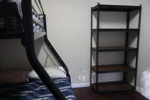 a bedroom with a bunk bed and a ladder to a bunk bed at Normalee manor hostel in Deanmill
