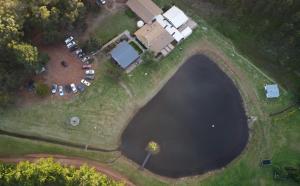 an aerial view of a lake with a group of parked cars at Normalee manor hostel in Deanmill