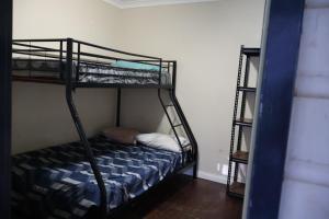 a room with two bunk beds and a ladder at Normalee manor hostel in Deanmill