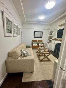 a living room with a couch and a table at Pet Friendly Acer Arena Accommodation in Sydney