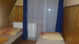 Posteľ alebo postele v izbe v ubytovaní Pokoje Zakopane