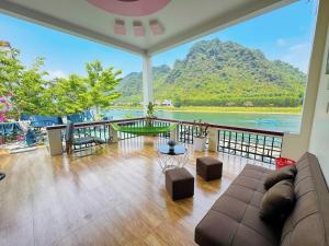 a living room with a couch and a view of the ocean at Funny Monkeys Homestay in Phong Nha