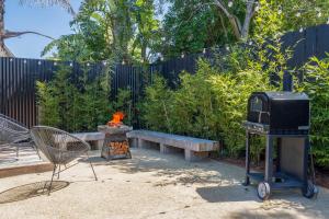 a backyard with a fire pit and a grill at The Pool House in Rosebud