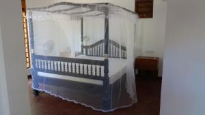 a bedroom with a bed with a canopy at Salt Lake Cabanas & Restaurant in Tangalle