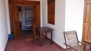 a room with a table and a bedroom with a crib at Salt Lake Cabanas & Restaurant in Tangalle +44 photos