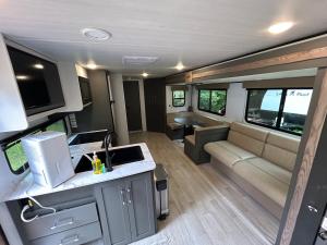 a kitchen and living room of an rv at The Bunkhouse Camper in Klamath