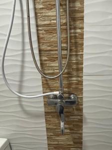 a hose hooked up to a wall with a chord at Three Bedrooms Two Storey Home with Parking in Santa Rosa +54 photos