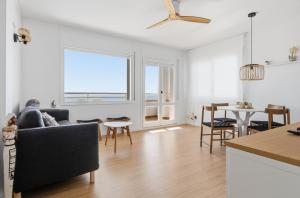 a living room with a couch and a table at Vista Roses Mar - Ariadna in Roses