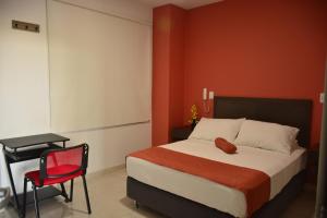 Säng eller sängar i ett rum på Hotel Confort Ariari
