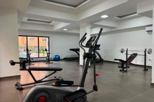 a gym with several exercise bikes in a room at Fafje Luxury in Mama