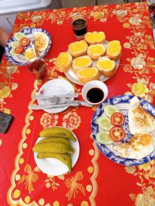 a table with plates of food and fruit on it at New Nhat Minh HomeStay & Tour in Ninh Binh