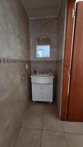 a bathroom with a sink and a mirror at Las Lomitas in Lincoln