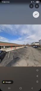 a photo of a parking lot with a car dealership at Lee motel in Nashville