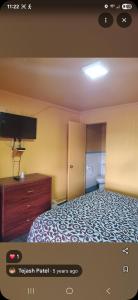 a bedroom with a bed with a tv and a dresser at Lee motel in Nashville