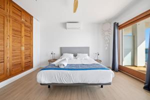 a bedroom with a bed and a large window at Vista Roses Mar - El Brancs in Roses