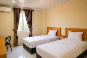 a hotel room with two beds and a window at Hotel Grand Langkawi By ZIRI in Lheue +38 photos