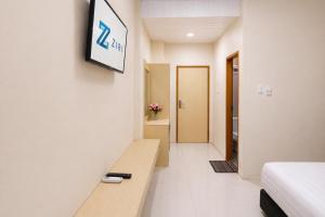 a hotel room with a sign on a wall at Hotel Grand Langkawi By ZIRI in Lheue