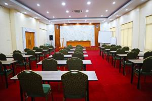 a conference room with tables and chairs and a screen at Hotel Grand Langkawi By ZIRI in Lheue