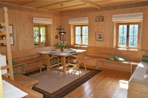 a dining room with a table and chairs at Kohlstatt Hof Ferienhaus in Verano