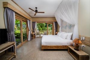 a bedroom with a bed and a large window at Lahana Resort Phu Quoc & Spa in Phú Quốc