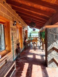a porch of a house with a table and benches at Villa Rancho el piñón in Ezequiel Montes